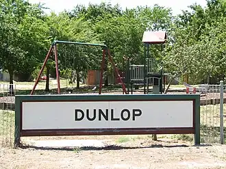 A Dunlop suburb sign at a local park.