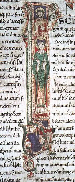 Illuminated manuscript illustration of a capital letter. At the top, there is a small box containing a man's head circled by a halo. The middle section is a long box containing a full-length figure of a man carrying a crozier and wearing bishop's robes. At the bottom is a small box containing a kneeling man with a tonsure staring upwards at the full-length figure.