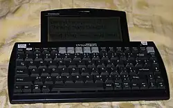 a communication device resembling a computer keyboard with a small liquid-crystal display attached to the top