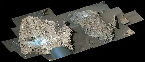 Perseverance's Mastcam-Z views the "Cheyava Falls" workspace. On the left, a black hole is visible that appeared after sample collection.[17]