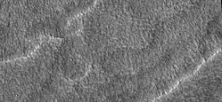 Close-up of scalloped ground, as seen by HiRISE under HiWish program. Surface is divided into polygons; these forms are common where ground freezes and thaws. Note: this is an enlargement of a previous image.