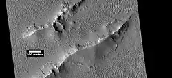 Layers and dark slope streaks in Lycus Sulci, as seen by HiRISE under HiWish program