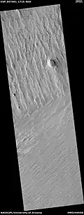 Wide view of yardangs, as seen by HiRISE under HiWish program This image is odd in that the yardangs are lined up in different directions in the top and bottom part of image. The wind direction probably changed to cause this. Location is Memnonia quadrangle.