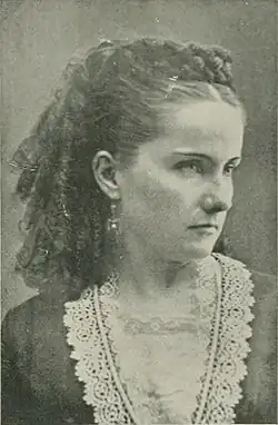 B&W portrait photo of a young woman with her hair in ringlets.