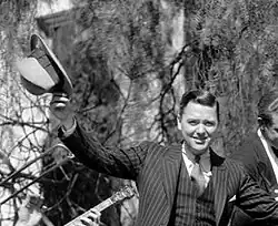 Earl Burtnett holding hat