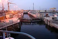 A boat lock in a dam on a river.