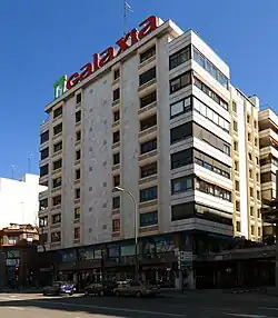 A mid size building with white exterior