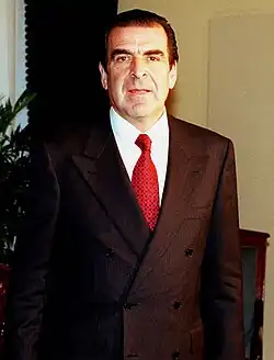 Image 67A man wearing a power suit, popular in the European workplace. The suit jacket is double-breasted with large shoulder pads. Photograph taken in 1998. (from 1990s in fashion)