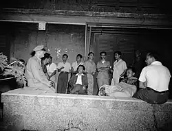 Arrested Indonesian leaders, including A.K. Gani and Tamzil, sit on a veranda, 1947