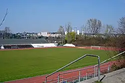 Association football pitch,, surrounded by running track