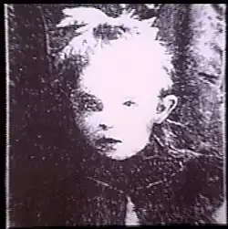 A grainy black and white photo of a young girl
