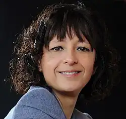 a photograph of Charpentier, a white woman with curly brown hair, smiling slightly