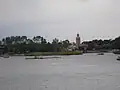 The Morocco pavilion as seen from across World Showcase Lagoon; The Twilight Zone Tower of Terror, whose top is designed to blend in with the pavilion, can be seen beyond the treetops.