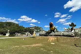 Statue of Saint Sebastian and a big periquito (parakeet)