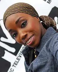 Estelle, smiling, in a blue jacket