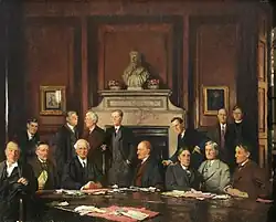 "University College Fellows", 1934: grouped under the college's bust of King Alfred are D. L. Keir, E. W. Ainley-Walker, A. D. Gardner, G. D. H. Cole, J. P. R. Maud, A. L. Goodhart, J. H. S. Wild, E. J. Bowen, A. B. Poynton, Sir Michael Sadler, A. S. L. Farquharson, E. F. Carritt, G. H. Stevenson and K. K. M. Leys.[4]