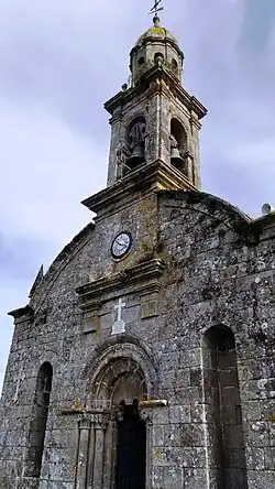 Details of the facade of the church of San Salvador de Escuadro and its campanile.