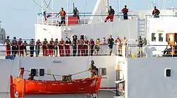 Image 54The crew of the merchant vessel Faina stand on the deck after a U.S. Navy request to check on their health and welfare. The Belize-flagged cargo ship owned and operated by Kaalbye Shipping, Ukraine, was seized by pirates 25 September 2008 and forced to proceed to anchorage off the Somali coast. The ship was carrying a cargo of Ukrainian T-72 tanks and related military equipment. (from Piracy off the coast of Somalia)