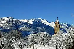 A view of the church and the surrounding mountains in winter