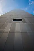 The Federal Reserve Bank of Boston viewed from the side at street level. The entire building is covered with a matte aluminum paneling