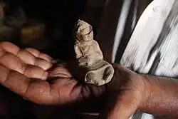 Human figurine dating to 1st century CE being held by Jitamitra Prasad Singhdeo. Find site- Nuapada, Odisha