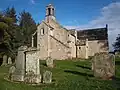 View towards southwest facade of Fogo Kirk, gravestones