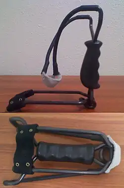 A folding, steel framed wrist brace slingshot using tubular bands.