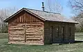 A reconstruction of the Fort Robinson adjutant office in Nebraska has corner post construction with log infill.