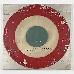 Fragment of sheet metal with a roundel