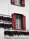 Traditional Espelette house with peppers drying on the walls