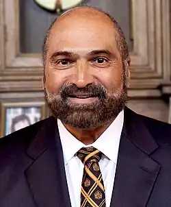 Posed head-and-shoulders photograph of Harris wearing a black tuxedo and black tie