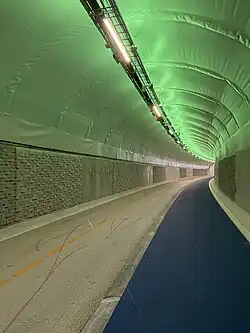 Fyllingsdalstunellen in Norway, a shared-use tunnel (i.e. with a bike lane and footpath; not strictly a cycling tunnel) with a slightly elevated sidewalk