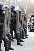 Gendarmes mobiles equipped with shields and gas mask