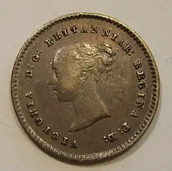 Silver coin with a woman's head facing left