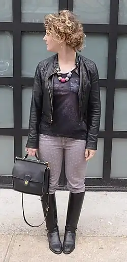 Image 85Woman in 2013 wearing galaxy-print top, leather moto jacket, statement necklace, and riding boots. (from 2010s in fashion)
