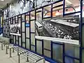 Transjakarta history gallery, featuring a photograph of the inauguration of the system at Gelora Bung Karno (now Senayan Bank Jakarta) station on 15 January 2004