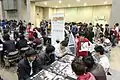 Magic: the Gathering teaching caravan by Wizards of the Coast, free promotion decks distributed.