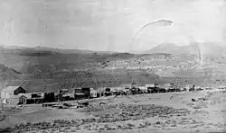 Gardiner, Park County, Montana, looking northeast, 1887. A one-sided street backed up to rocky foothills.