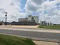 Silos can be seen on Texas 71 across from the school.