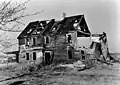 Archival photograph of the ruin of the house taken circa 1935, before it fell down entirely in 1938[6]