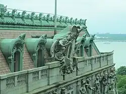 View of the upper facade of the Alexander Hamilton U.S. Custom House, with architectural sculptures, from an adjacent building, in Manhattan.
