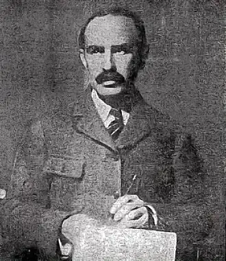 Soper, wearing a jacket and tie