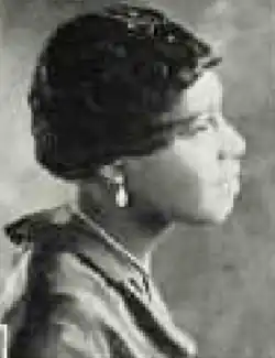 A young Black woman with short dark hair, photographed in profile
