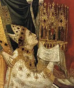 ... who is holding the triptych itself.