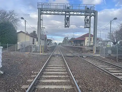 View of the station buildings and platforms from the nearby level crossing