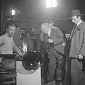 A man wearing a mourning band on his lapel in a glassworks, Sweden, ca 1940–41[3]