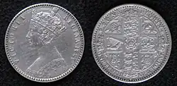 Both sides of a silver coin, with a crowned woman on one side and shields on the other