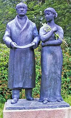 Bronze statue titled Goethe and Ulrike by Heinrich Drake, showing Johann Wolfgang von Goethe standing beside a young woman, displayed outdoors in Marienbad.
