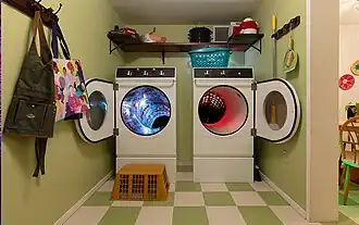 Interior view showing the washer-and-dryer portal installation at The Real Unreal
