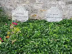Two graves and two gravestones side by side; heading behind a bed of green leaves, bearing the remains of Vincent and Theo van Gogh, where they lie in the cemetery of Auvers-sur-Oise. The stone to the left bears the inscription: Ici Repose Vincent van Gogh (1853–1890) and the stone to the right reads: Ici Repose Theodore van Gogh (1857–1891)